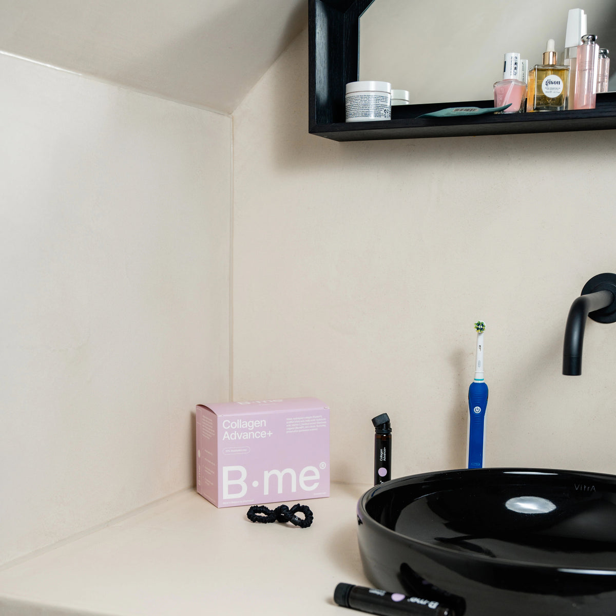 B.me Collagen Advance+ shot in a bathroom with black sink and headband in view