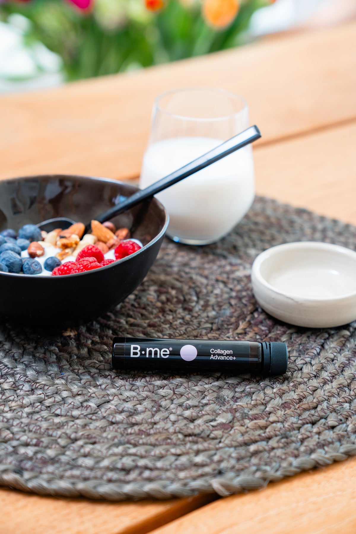 Yogurt breakfast with blueberries, raspberries, and nuts served with oat milk and B.me Collagen Advance+ shot